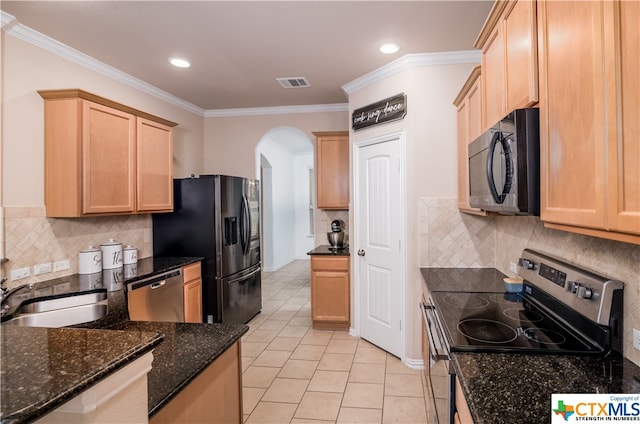 kitchen featuring appliances with stainless steel finishes, sink, and crown molding