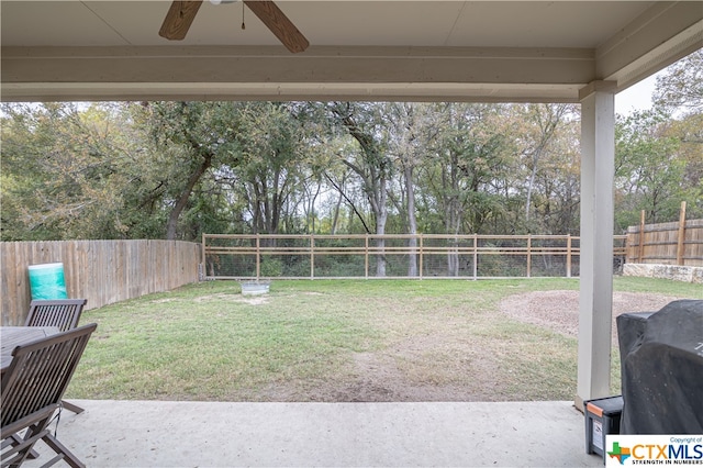 view of yard with a patio and ceiling fan