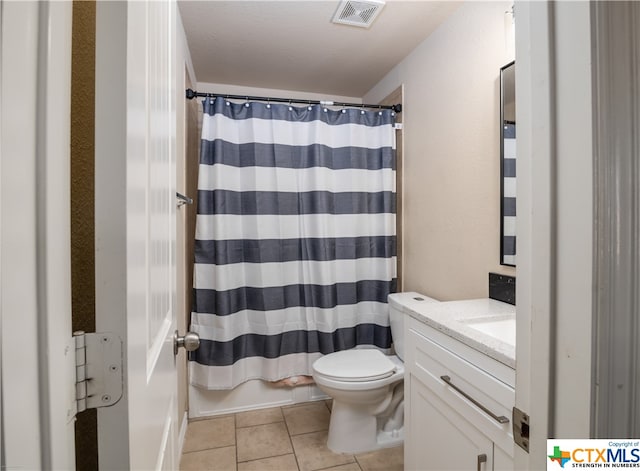 bathroom with tile patterned flooring, vanity, toilet, and a shower with shower curtain