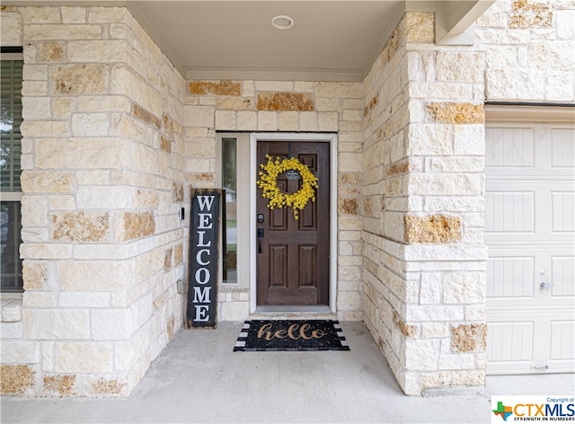 view of exterior entry featuring a garage