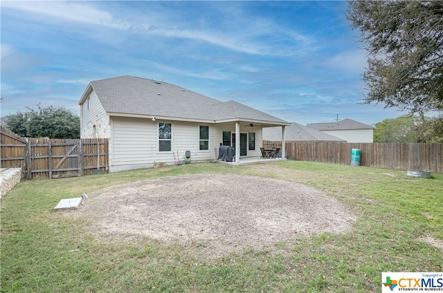 back of property featuring a yard and a patio area