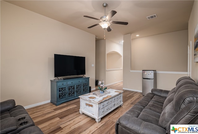 living room featuring ceiling fan and light wood-type flooring