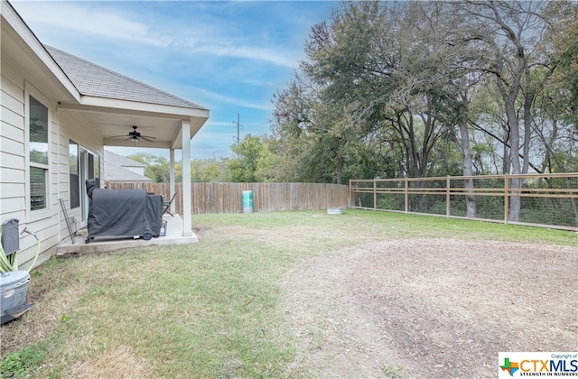 view of yard with ceiling fan