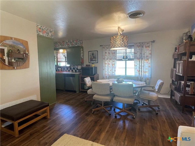 dining area featuring wood finished floors, visible vents, and a wealth of natural light