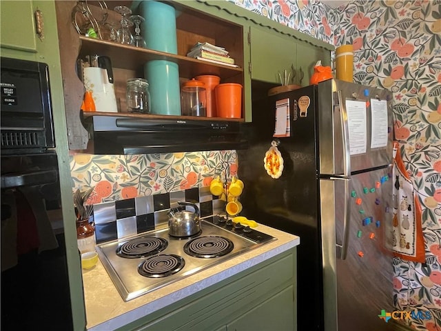 kitchen featuring open shelves, under cabinet range hood, stainless steel appliances, wallpapered walls, and green cabinetry