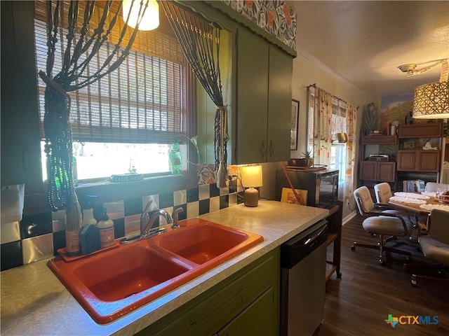 kitchen featuring a sink, dark wood-style floors, green cabinets, light countertops, and dishwasher