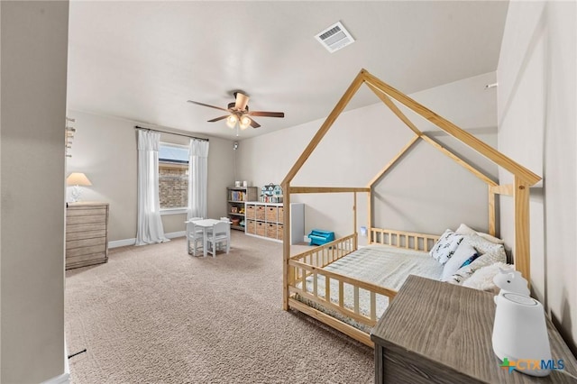 carpeted bedroom with visible vents, a ceiling fan, and baseboards