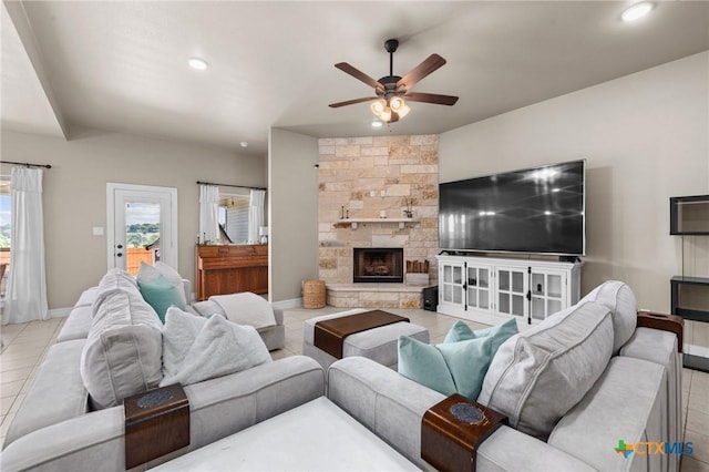 tiled living room with recessed lighting, a stone fireplace, baseboards, and ceiling fan