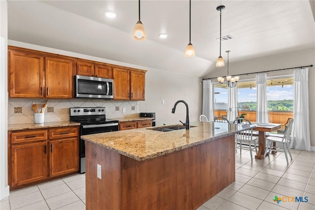 kitchen featuring stainless steel appliances, vaulted ceiling, a sink, light tile patterned flooring, and tasteful backsplash