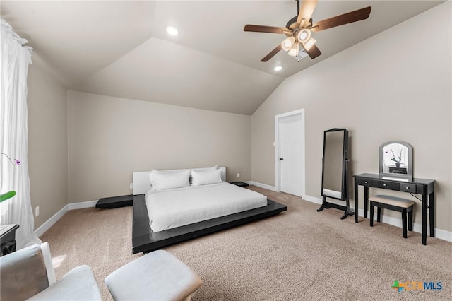 bedroom featuring light colored carpet, lofted ceiling, and baseboards