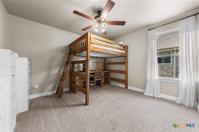 unfurnished bedroom featuring a ceiling fan, baseboards, and carpet flooring
