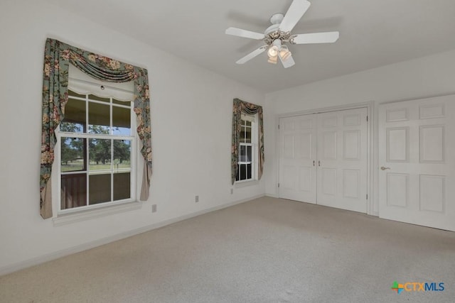 82 Bell Mountain Rd, Fredericksburg, TX 78675 - unfurnished bedroom featuring carpet flooring, a closet, baseboards, and a ceiling fan
