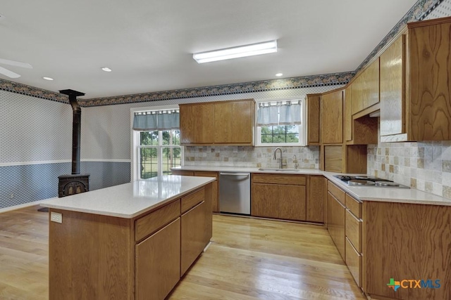 82 Bell Mountain Rd, Fredericksburg, TX 78675 - kitchen featuring stainless steel appliances, a sink, light wood-type flooring, plenty of natural light, and wallpapered walls