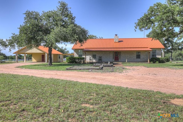 82 Bell Mountain Rd, Fredericksburg, TX 78675 - rear view of property with a chimney, a yard, driveway, and metal roof