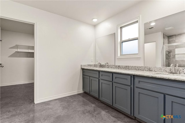 bathroom featuring walk in shower, vanity, and concrete floors