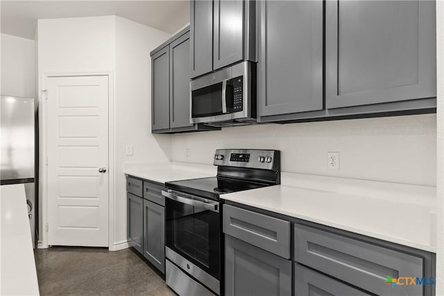 kitchen with stainless steel appliances and gray cabinets