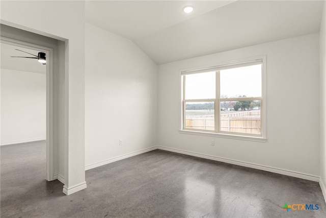 empty room featuring lofted ceiling