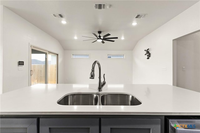 kitchen featuring lofted ceiling, sink, a center island with sink, and ceiling fan