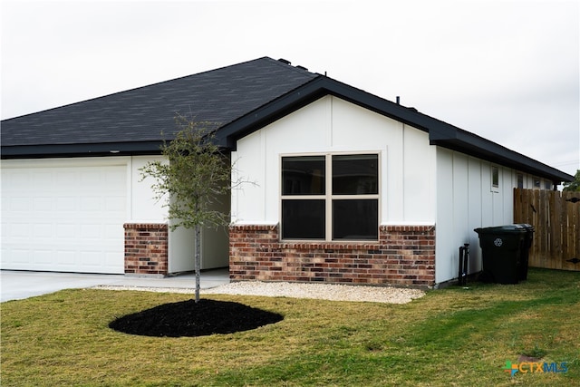 view of home's exterior featuring a garage and a yard