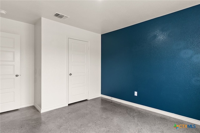 unfurnished bedroom featuring concrete floors