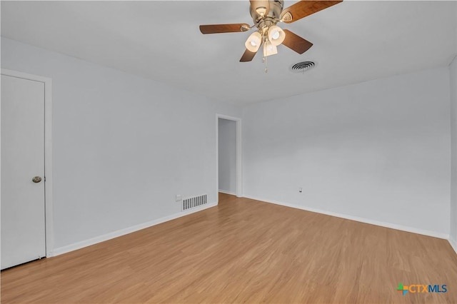 empty room featuring ceiling fan and light wood-type flooring