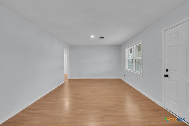 unfurnished room featuring light hardwood / wood-style floors