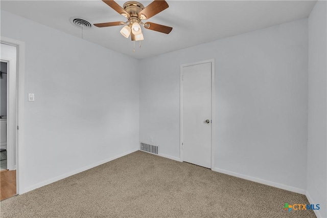 empty room featuring light colored carpet and ceiling fan