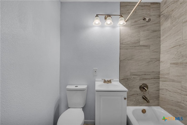 full bathroom featuring vanity, tiled shower / bath combo, and toilet