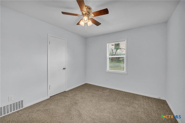 empty room with ceiling fan and carpet