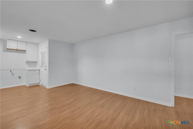 spare room with light hardwood / wood-style floors