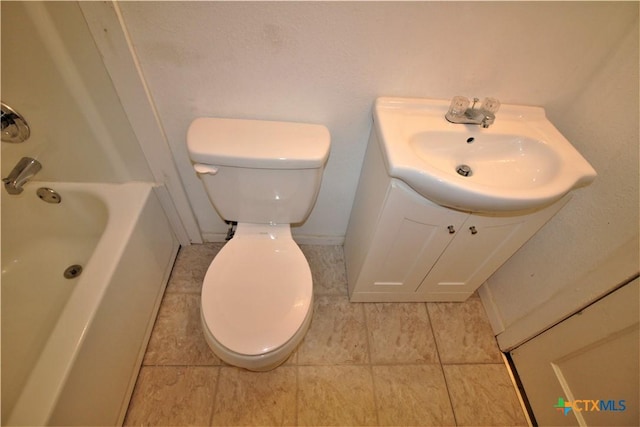 bathroom with tile patterned floors, vanity, and toilet