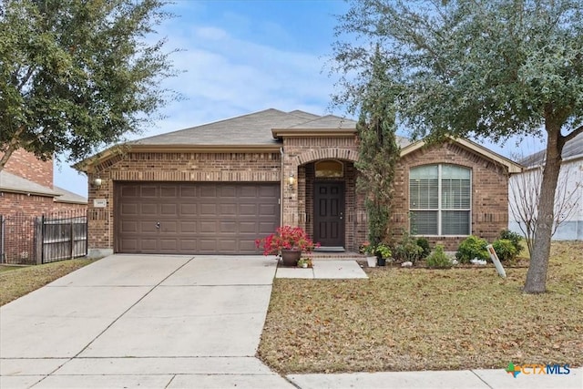 ranch-style house featuring a garage and a front lawn