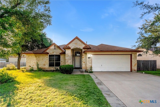 view of front of house with a garage and a front lawn