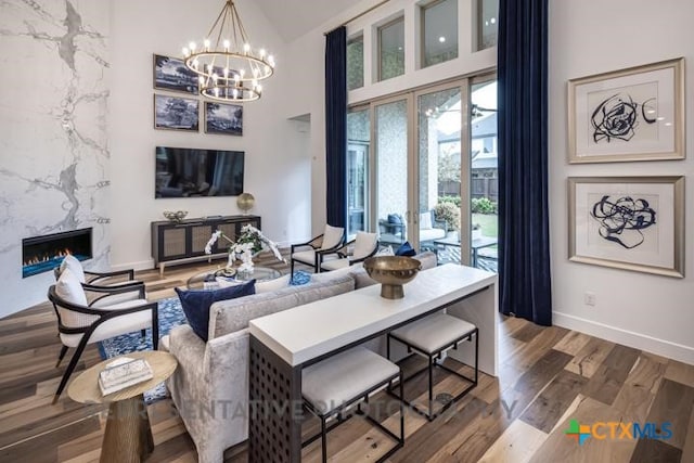 322 Dulce Vis, Boerne, TX 78006 - living room featuring a chandelier, baseboards, a premium fireplace, wood finished floors, and french doors