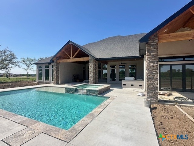 view of swimming pool featuring a patio area, french doors, a ceiling fan, and a pool with connected hot tub