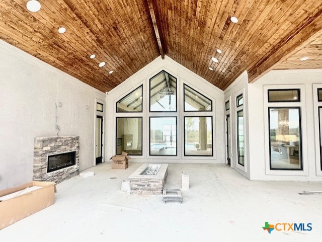 living area featuring wood ceiling, lofted ceiling, and a fireplace