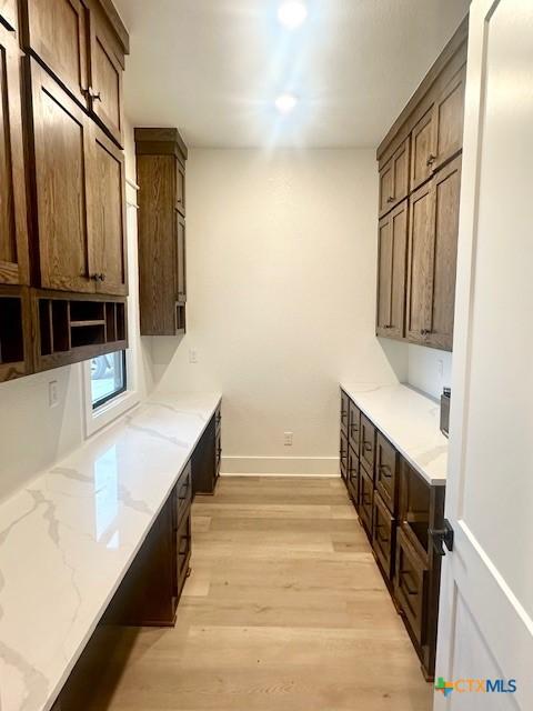 washroom featuring light wood-type flooring and baseboards