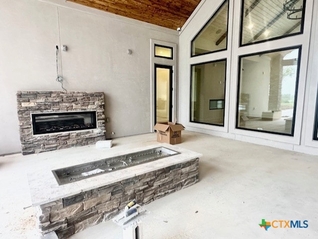 view of patio / terrace featuring a stone fireplace