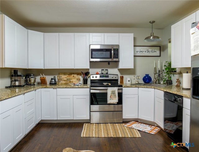 kitchen featuring white cabinets, hanging light fixtures, dark wood-type flooring, and appliances with stainless steel finishes