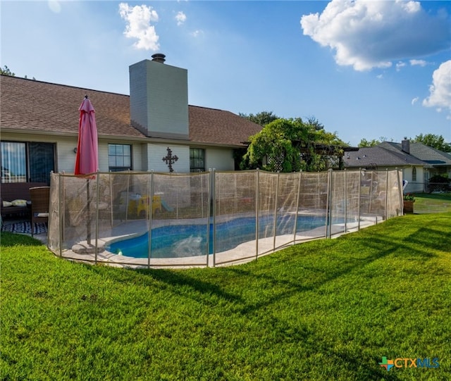 view of pool featuring a yard