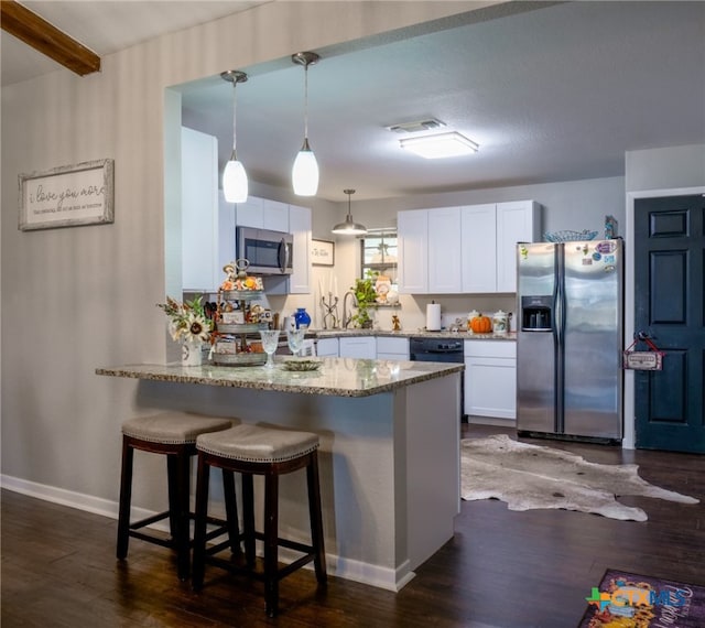 kitchen with dark hardwood / wood-style flooring, white cabinets, and stainless steel appliances