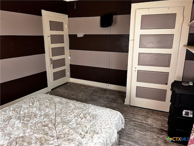 bedroom featuring wood finished floors and a closet