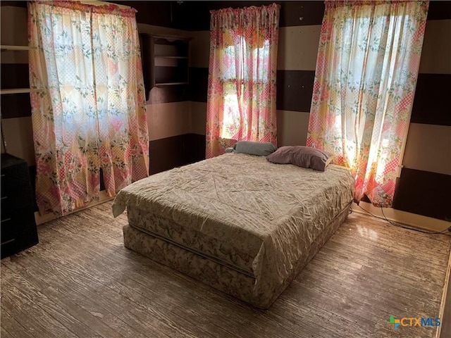 bedroom with wood finished floors