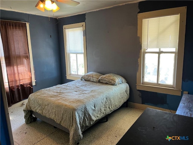 bedroom featuring ceiling fan and ornamental molding