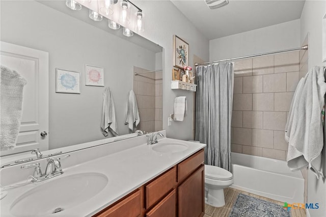 full bathroom featuring shower / bath combo with shower curtain, vanity, and toilet