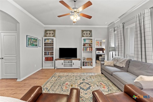 living room with ceiling fan, ornamental molding, and light hardwood / wood-style flooring