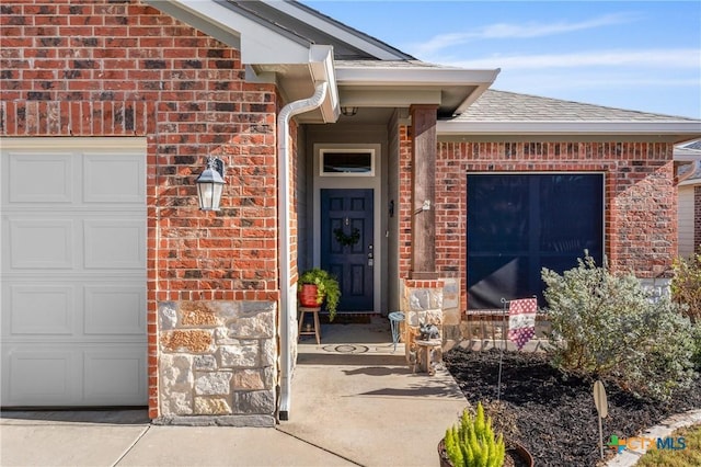 doorway to property with a garage