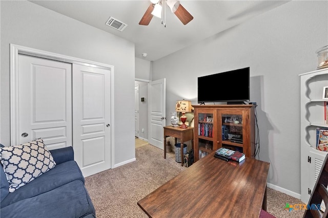 home office featuring light carpet and ceiling fan