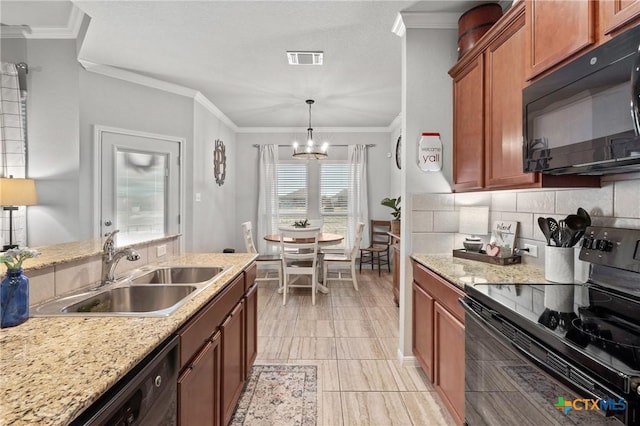 kitchen featuring pendant lighting, backsplash, black appliances, sink, and a chandelier