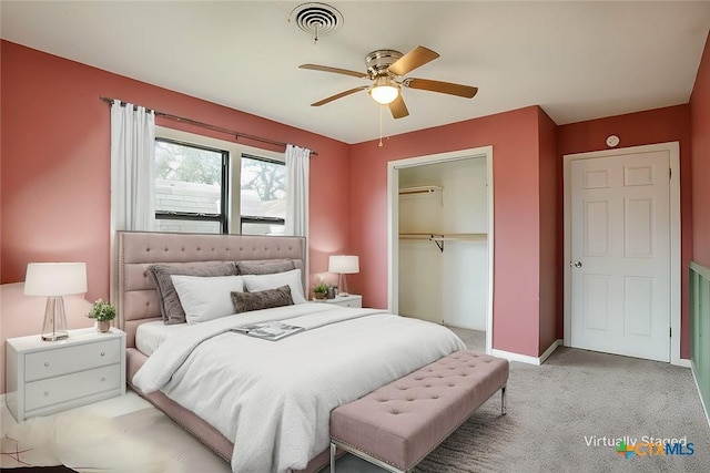 bedroom featuring visible vents, baseboards, light colored carpet, ceiling fan, and a closet